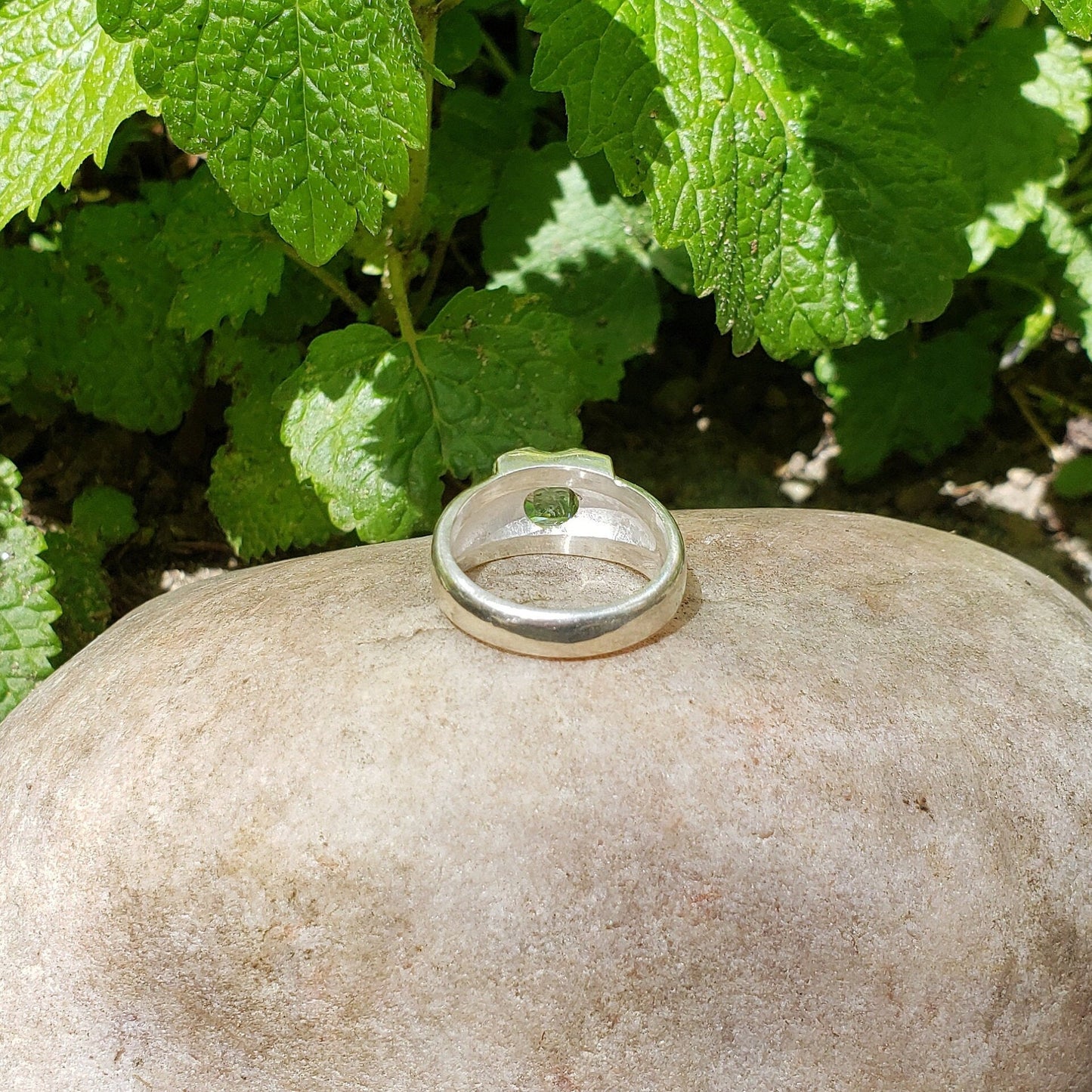 Tongue out reverse intaglio face in a Heliodor ring