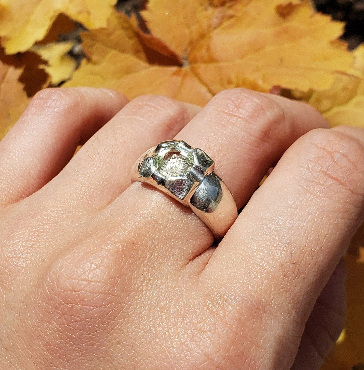 Tongue out reverse intaglio face in a Heliodor ring