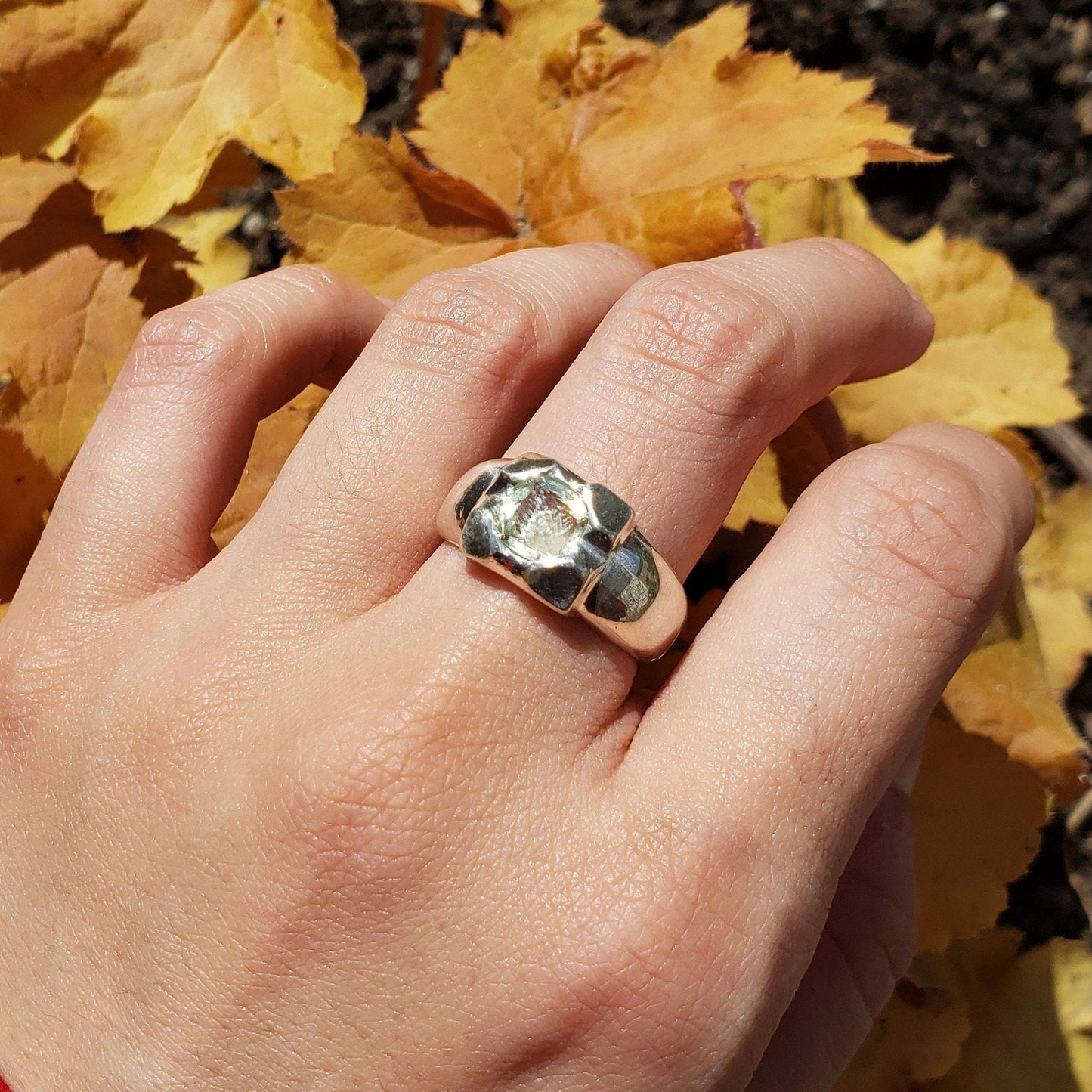 Tongue out reverse intaglio face in a Heliodor ring