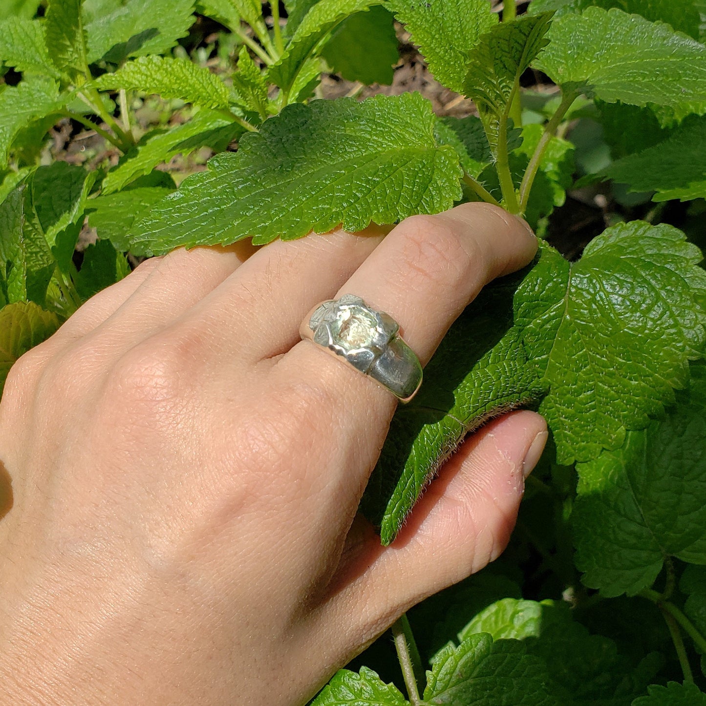 Tongue out reverse intaglio face in a Heliodor ring