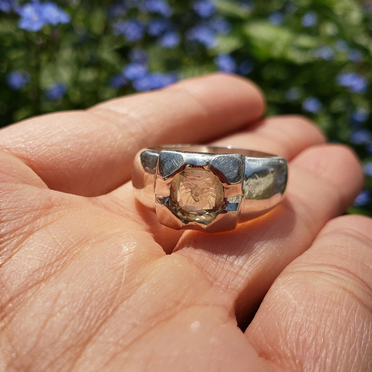 Tongue out reverse intaglio face in a Heliodor ring