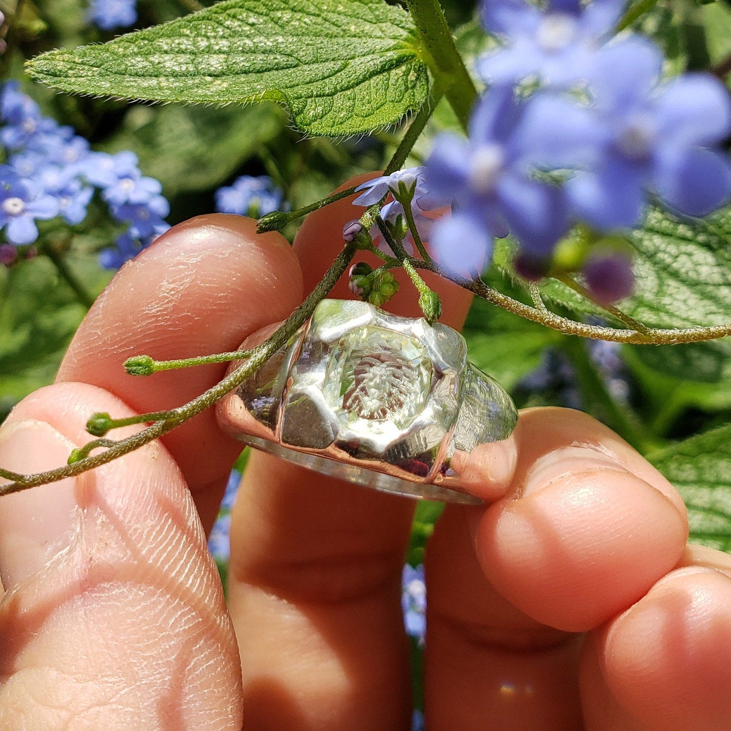 Tongue out reverse intaglio face in a Heliodor ring