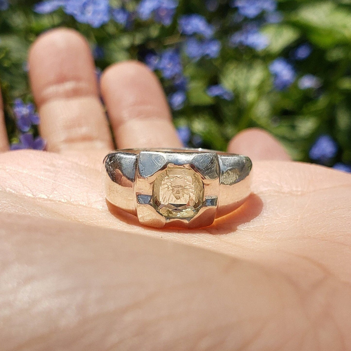 Tongue out reverse intaglio face in a Heliodor ring