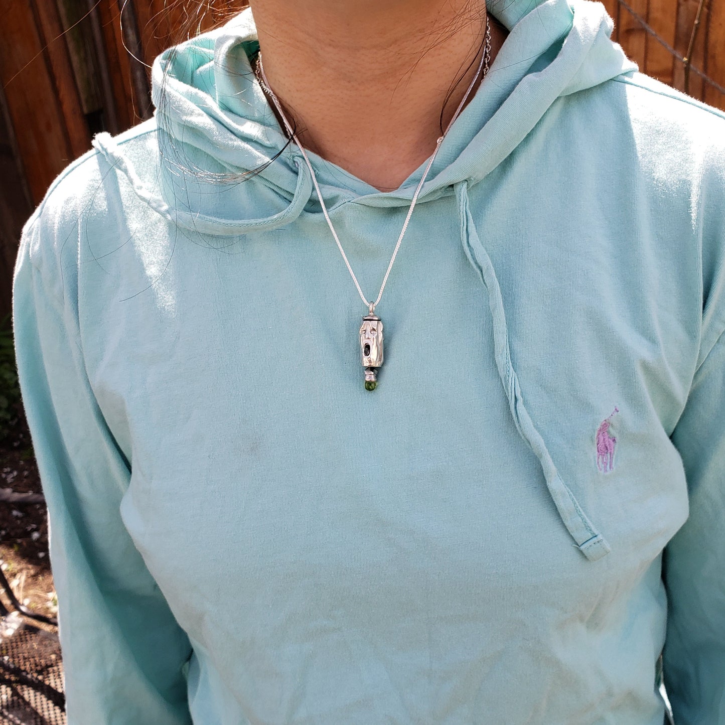 Three face and peridot jangling pendant