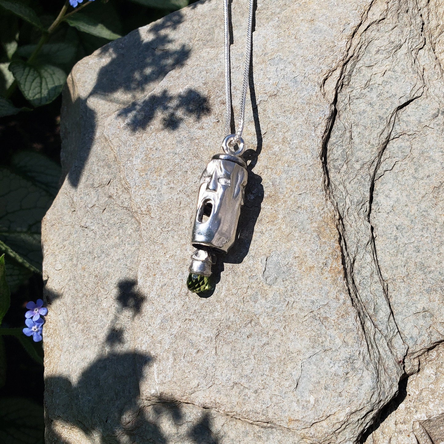 Three face and peridot jangling pendant