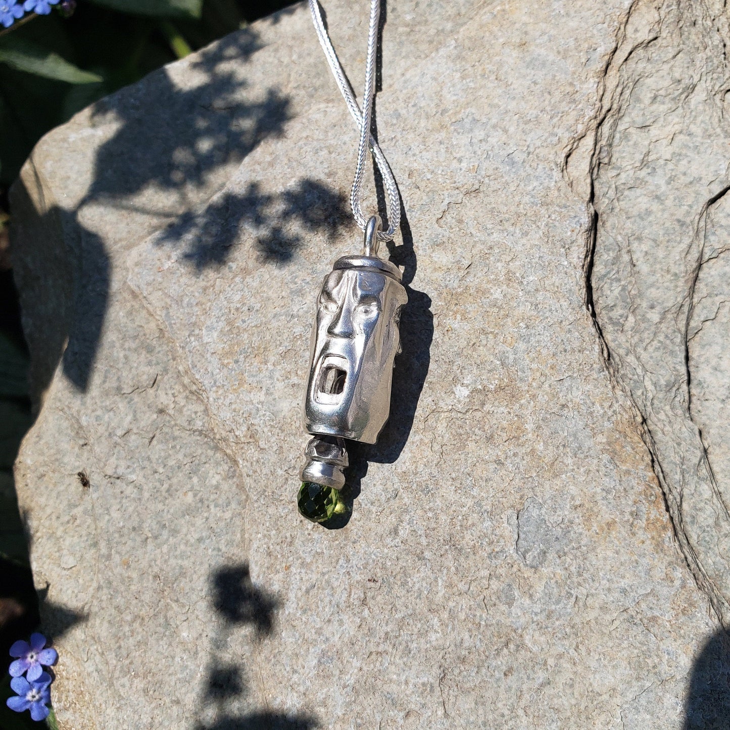 Three face and peridot jangling pendant