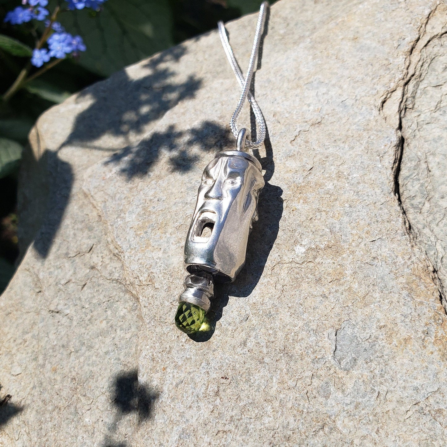 Three face and peridot jangling pendant