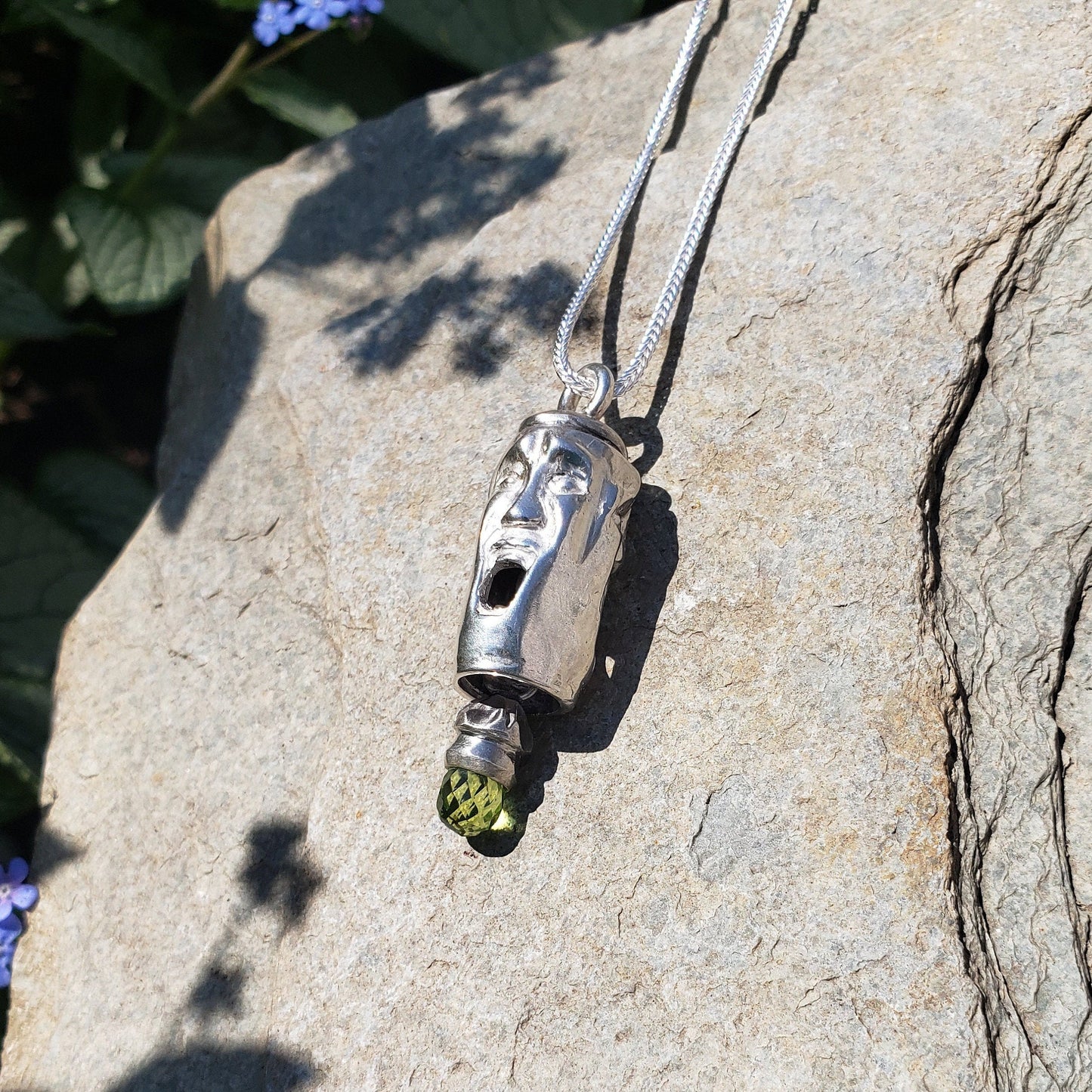 Three face and peridot jangling pendant