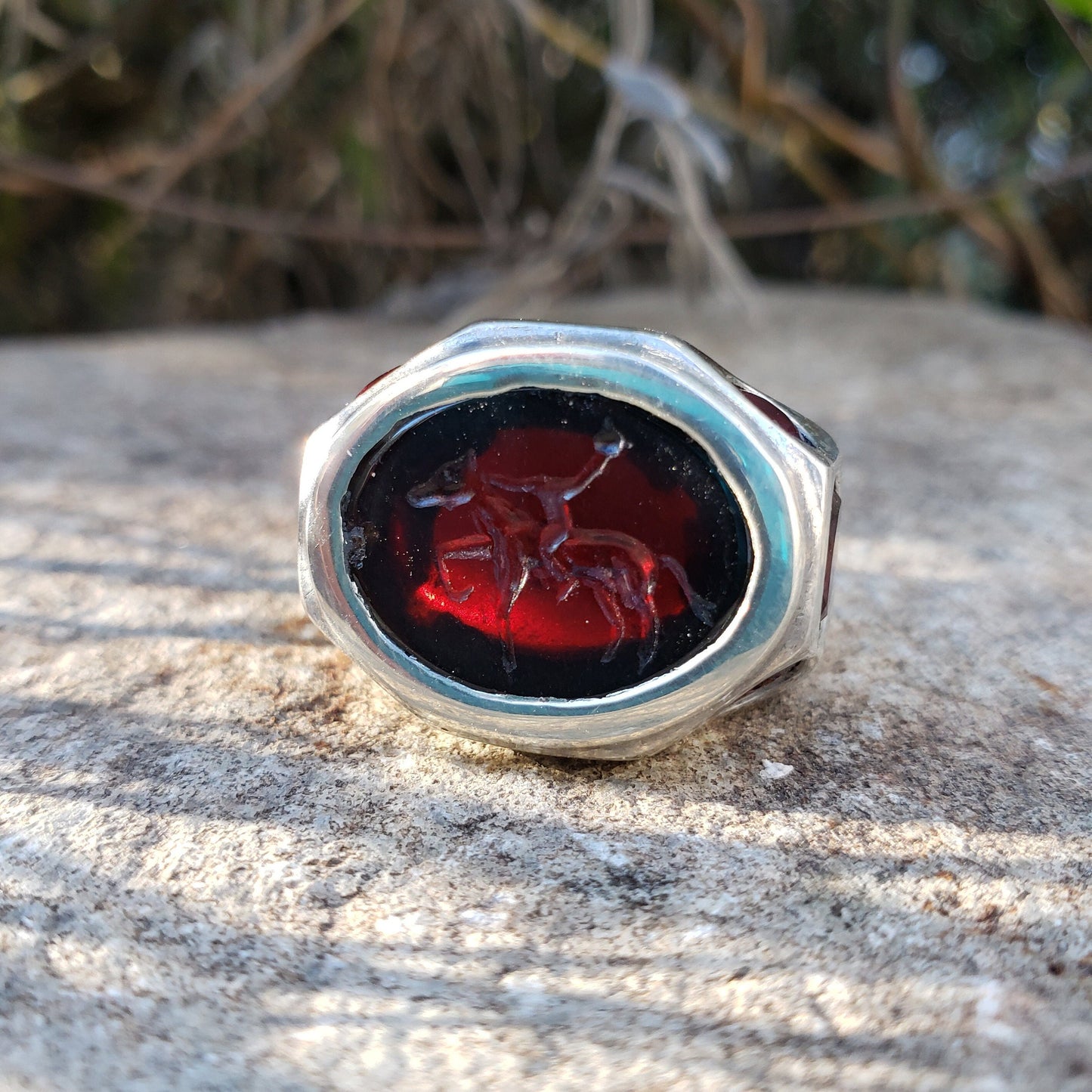 Headless horseman intaglio garnet signet ring