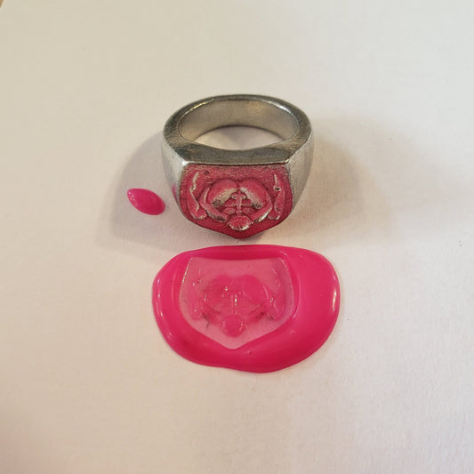 Autofellatio wax seal signet ring